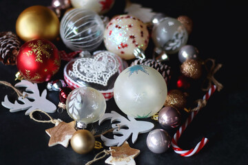 Various colorful Christmas ornaments on dark background. Selective focus.