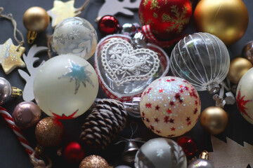 Various colorful Christmas ornaments on dark background. Selective focus.