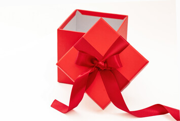 Red gift box with ribbon and bow open isolated on white background,