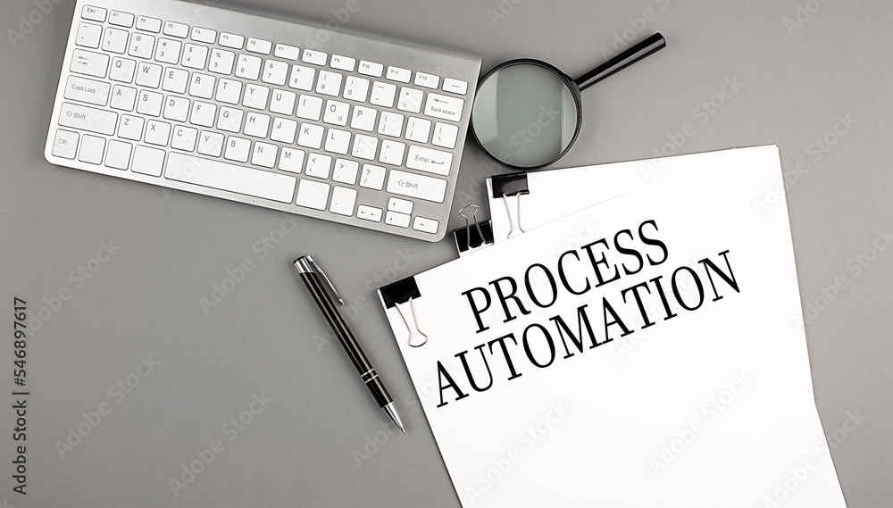 Poster process automation text on paper with keyboard, magnifier and pen. business concept
