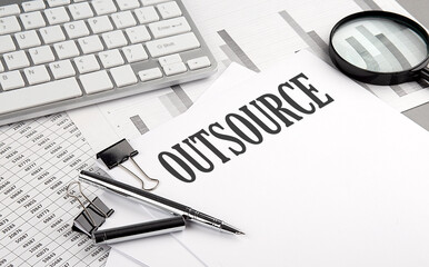 OUTSOURCING text on paper with chart and keyboard, business concept