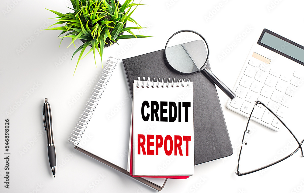 Poster text credit report on notebook with office tools on white background