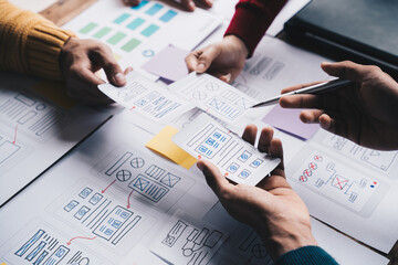 Young Asian business creative team work together, mobile application software design project. Brainstorm meeting, internet technology, smartphone web app designer, office coworker teamwork concept.