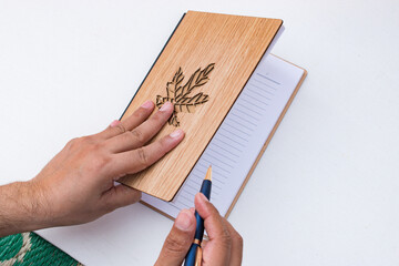 Hand of men opening a diary for writing plan, goal and aims. New year resolution. White background