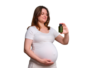 Portrait of a pregnant woman with a bottle of body oil, white background