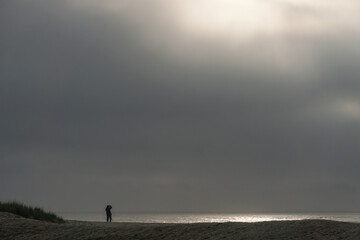 Assateague National Seashore, Virginia: A solitary photographer captures sunrise on the Atlantic Ocean.