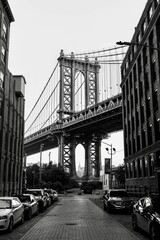 Vertical and monochrome shot of the Brooklyn bridge in New York City