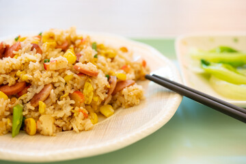 angle view fried rice with crab sticks and sausages and maizes horizontal composition