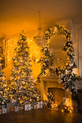 warm and cozy evening in Christmas room interior design,Xmas tree decorated by lights presents gifts,toys, deer,candles, lanterns, garland lighting indoors fireplace.holiday living room.magic New year