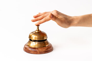 Metal golden hotel service bell with hand. Attention concept