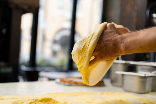 In Restaurant Professional Chef Preparing Pizza, Kneading Dough, flouring it. Cooking Delicious Organic Food. Slow Motion Cinematic