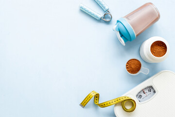 Whey protein powder in jar and scales. Fitness and gym food diet