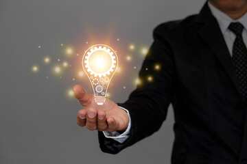 Hand of man show illuminated light bulb. Concept creativity with bulbs that shine glitter. Idea about innovation and inspiration concept. Inspiration of ideas for sustainable business development