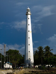 An old  lighthouse is standing still in the coastal area