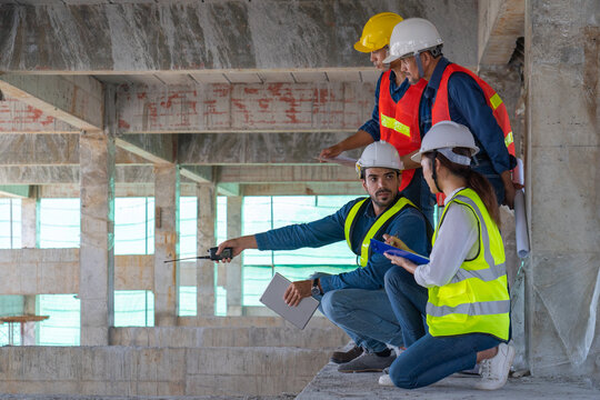 team of civil engineer manager, maintenance supervisor, professional technician foreman together with safety operator inspect and discuss the infrastructure of building construction progress at site