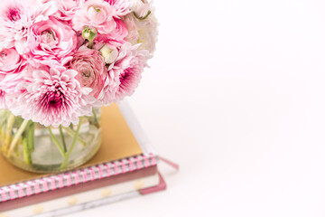 A femininely styled desktop in shades in gold and dusty pink with modem stationery. Lifestyle theme...