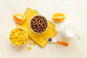Obraz na płótnie Canvas Kids morning with corn flakes milk and orange for breakfast