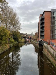 River view with buildings and bridges. Castlefield Manchester England. 
