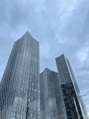 Looking up at modern buildings with a sky background. Taken in Manchester City centre. 