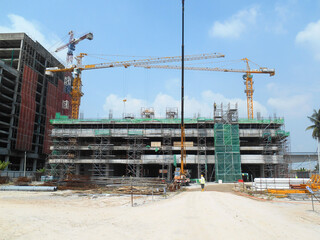 JOHOR, MALAYSIA -JUNE 18, 2020: Building construction work is underway at a construction site. The safety of the site is taken very seriously and emphasized. Construction workers are busy.