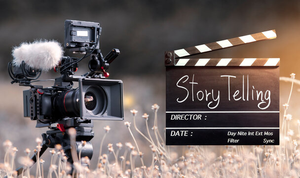 Storytelling.handwriting on film slate and a camera filming a movie in the outdoor background
