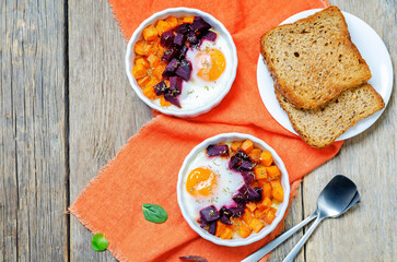 Beet Sweet potato baked eggs on a wood background