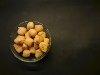 Tofu crispy in a glass bowl with black background