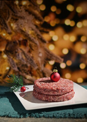 Fototapeta na wymiar Beef Raw Minced Homemade Meat with Red Christmas Ball onTop
