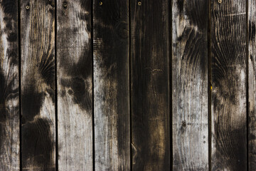 Backdrop with fence made of burnt wood. Black and white planks