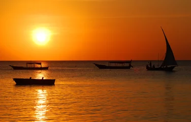 Photo sur Plexiglas Plage de Nungwi, Tanzanie Fisherman Boat at sunset, Taken at Nungwi Village, Zanzibar Island, Tanzania Nungwi. Nungwi is traditionally the centre of Zanzibar's dhow-building industry.