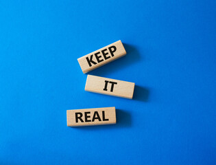 Keep it real symbol. Concept word Keep it real on wooden blocks. Beautiful blue background. Business and Keep it real concept. Copy space