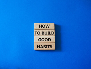 How to build good habits symbol. Concept words How to build good habits on wooden blocks. Beautiful blue background. Business and How to build good habits concept. Copy space.