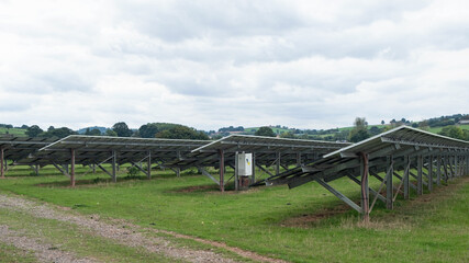 Back view of arrays of solar panels installed on a farm in East Devon, UK