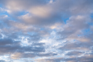 Beautiful sunset or sunrise sky, illuminating dark blue and pale pink clouds. Cloudy sky to overlay on your photos.