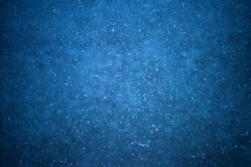 Dark blue ice with frozen bubbles with the texture of white frost. Background design concept