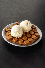 Hong Kong chocolate bubble waffle with ice cream on dark background with copy space.