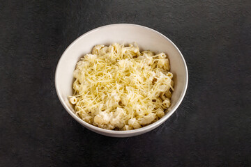 Mac and cheese. Traditional american fast food. Pasta with sauce from chedder parmesan mozarella and other cheese.