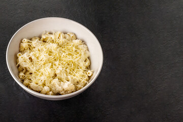 Mac and cheese. Traditional american fast food. Pasta with sauce from chedder parmesan mozarella and other cheese.