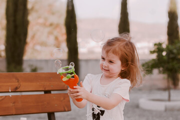 Little girl walking in park, having fun, enjoying warm weather.