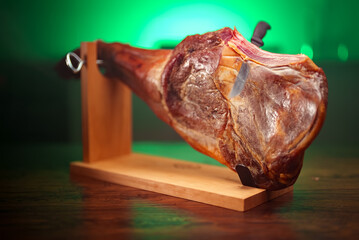 Dry-cured spanish ham. Jamon on a wooden stand.