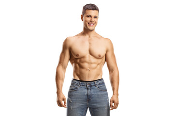 Fototapeta premium Muscular shirtless guy wearing jeans and looking at camera