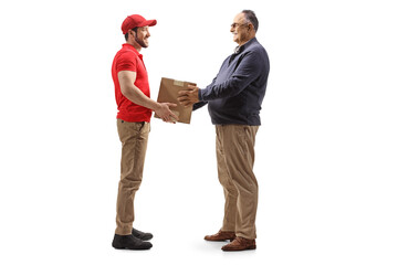 Full length profile shot of a mature man taking a cardboard box from a delivery man