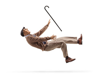 Elderly man with a walking cane falling