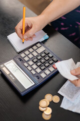 Female hand Calculate coin with notepad. Financial concept, Concept of accounting