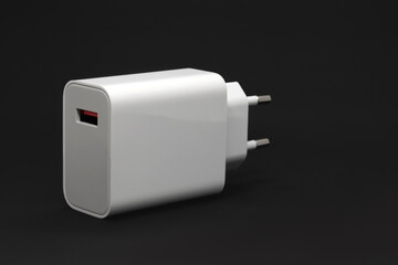 Electric Adapter to USB ports on a black background, mobile phone charger