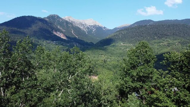 Areal drone footage from Karpenisi area, into the mountains and lake.