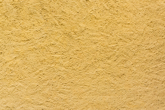 Texture giallo ocra molto ruvida, muro, cemento, sfondo grafico