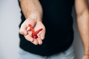 International AIDS Day. Man is holding red red ribbon. Promotes awareness. World Sexual Health Day.