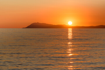 Fototapeta premium Scenic view of sun globe reflected to Mediterranean sea at golden sunset in south of France