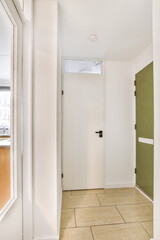 Interior of modern flat in minimal style with narrow empty corridor illuminated by lamps